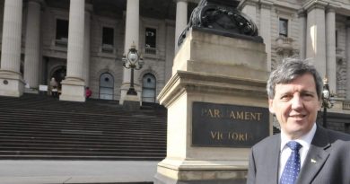 Robert Clark in front of Victorian Parliament building